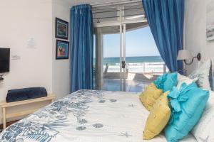 a bedroom with a bed with a view of the ocean at LA CRETE SANDS NO 1 in Margate