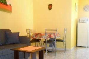 a living room with a table and chairs and a couch at Apartments with parking space Umag - 7109 in Umag