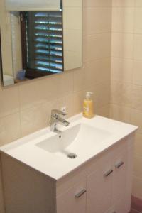 a bathroom with a white sink and a mirror at Apartments by the sea Fazana - 7192 in Fažana
