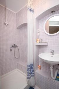 a pink bathroom with a sink and a shower at Studio Basanija 7148a in Savudrija