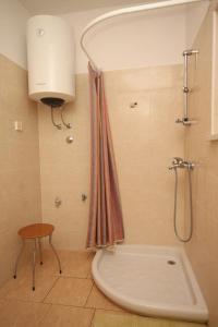 a bathroom with a shower with a tub and a sink at Apartment Basanija 7149b in Savudrija