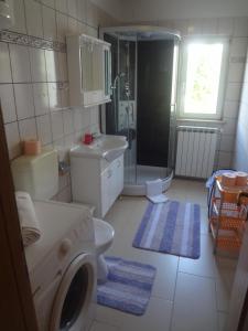 een badkamer met een wasmachine en een wastafel bij Apartment Valica 7122c in Umag