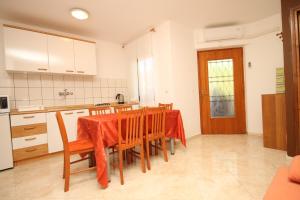 a kitchen with a table and chairs in a room at Apartments with parking space Fazana - 7153 in Fažana +19 photos