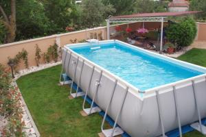 a large swimming pool in a yard with at Family friendly apartments with a swimming pool Lindar, Central Istria - Sredisnja Istra - 7197 in Pazin