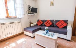 a living room with a couch and a coffee table at Family friendly apartments with a swimming pool Lindar, Central Istria - Sredisnja Istra - 7197 in Pazin