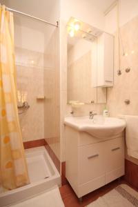 a bathroom with a sink and a shower at Apartment Fazana 7153b in Fažana