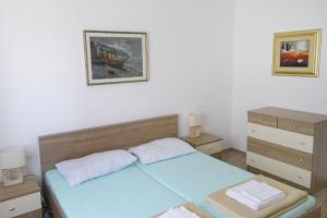a bedroom with a blue bed and a dresser at Family friendly seaside apartments Novigrad - 7118 in Novigrad Istria