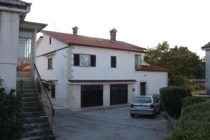 a car parked in front of a white house at Apartments with parking space Gracisce, Central Istria - Sredisnja Istra - 7134 in Gračišće
