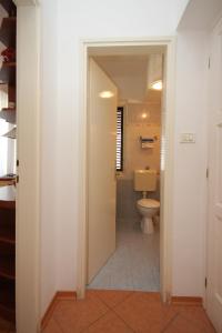 a hallway leading to a bathroom with a toilet at Apartments with a parking space Novigrad - 7121 in Novigrad Istria