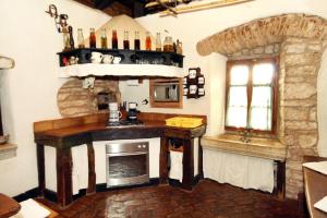 a kitchen with a stove and a fireplace at Family friendly house with a swimming pool Sveti Petar u Sumi, Central Istria - Sredisnja Istra - 7092 in Sveti Petar u Šumi