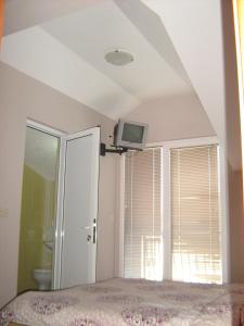 a bedroom with a bed and a tv on the ceiling at Mitko's Guest House in Ohrid +33 photos