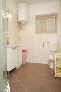 a bathroom with a toilet and a sink at Apartments with a parking space Heraki, Central Istria - Sredisnja Istra - 7167 in Stifanići