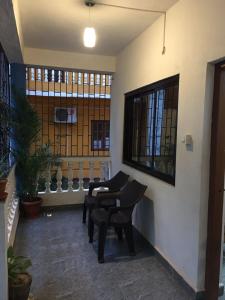 a room with chairs and a table and a window at Palolem Sunrise Apartment in Palolem