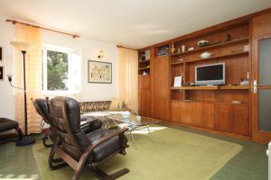 a living room with a chair and a television at Apartments with a parking space Rovinj - 7145 in Rovinj