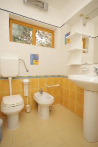 a bathroom with a toilet and a sink at Apartments with a parking space Rovinj - 7145 in Rovinj