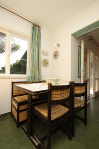 a dining room with a table and chairs and a window at Apartments with a parking space Rovinj - 7145 in Rovinj