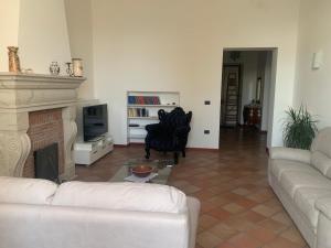 a living room with a couch and a fireplace at Guest house Il Palazzo Marchesale in Carife