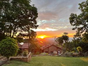 a house with the sunset in the background at The Haven in Nelspruit
