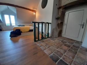 a room with a bedroom with a bed and a door at Chambre bohème au domaine de Fangorn in Glux