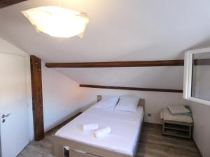 a small room with a white bed and a light at Maison moderne et spacieuse avec piscine in Villeurbanne +17 photos