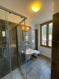 a bathroom with a shower and a sink and a toilet at Hotel La Verticale in Chamonix-Mont-Blanc