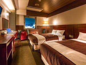 Krevet ili kreveti u jedinici u okviru objekta Tokai City Hotel