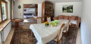 a living room with a table and a couch at Haus Waldrand in Oberndorf in Tirol