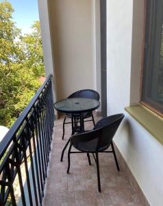 two chairs and a table on a balcony at Dzveli Ubani in Sighnaghi