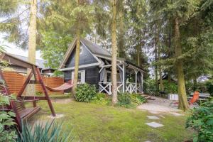 a house with a playground and a swing at Black&White in Kołczewo