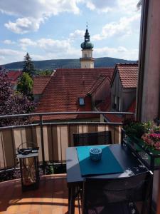 a balcony with a table and a lighthouse in the background at Aalens schönste Aussicht in Aalen