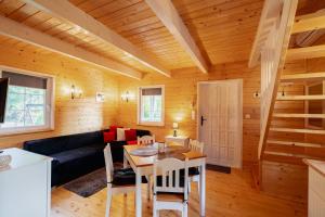 a living room with a couch and a table at Black&White in Kołczewo