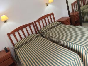 A bed or beds in a room at Hotel Atalayas Zafra