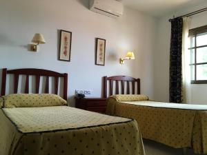 A bed or beds in a room at Hotel Atalayas Zafra
