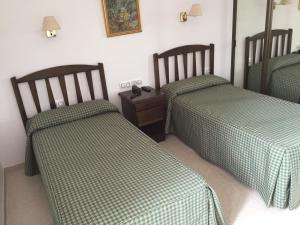 A bed or beds in a room at Hotel Atalayas Zafra