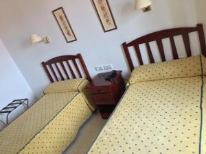 A bed or beds in a room at Hotel Atalayas Zafra