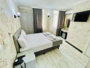 a bedroom with a bed and a desk and a television at Old City Viva Hotel in Istanbul