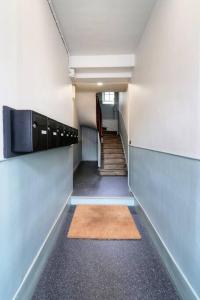 a hallway with a stairway with a stair mat in it at Le Beaumont in Rennes