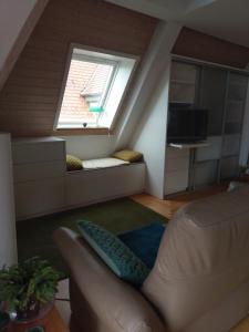 a living room with a couch and a window at Aalens schönste Aussicht in Aalen