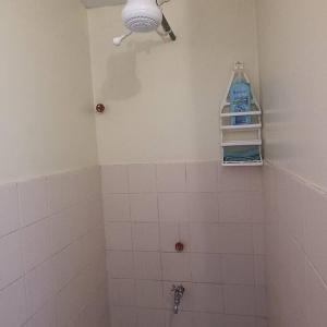 a bathroom with a shower with a bottle of bleach at Walk to Strathmore Uni, Java, Wilson Airport,tmall in Nairobi