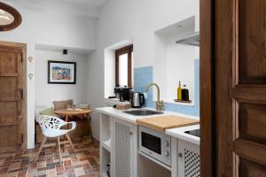 a small kitchen with a sink and a table at La AMARA Zaid - en el casco antiguo de Frigiliana in Frigiliana