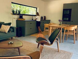 a woman is standing in the kitchen of a room at Osbos chalets in Lille