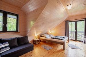 a room with a bed and a couch at Dom Black&White in Kołczewo