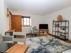 a living room with a couch and a tv at The Bothy in Peterhead