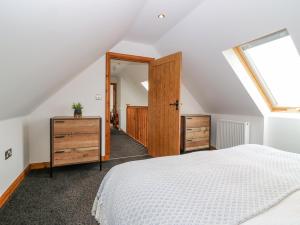 a attic bedroom with a bed and a skylight at The Bothy in Peterhead