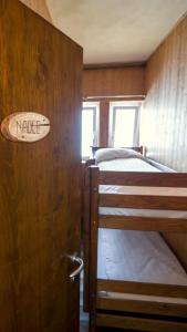 a bedroom with two bunk beds and a sign on a wall at Rifugio Chierego - 1911m in Brenzone sul Garda