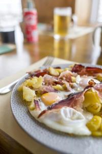 a plate of food with eggs on a table at Rifugio Chierego - 1911m in Brenzone sul Garda