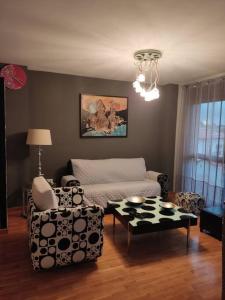 a living room with a couch and a table at Acogedor apartamento en Noreña in Noreña