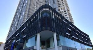 a tall building with a glass facade in front of it at The Landmark Seaview Netflix By Blue Sky Holidays in George Town