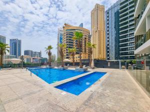 a swimming pool in a city with tall buildings at EDEN'S Homes & Villas - Sparkle Tower in Dubai