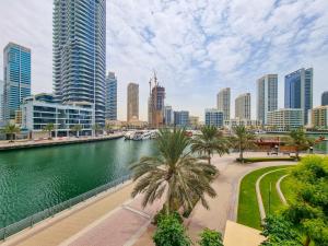 a river in a city with tall buildings at EDEN'S Homes & Villas - Sparkle Tower in Dubai